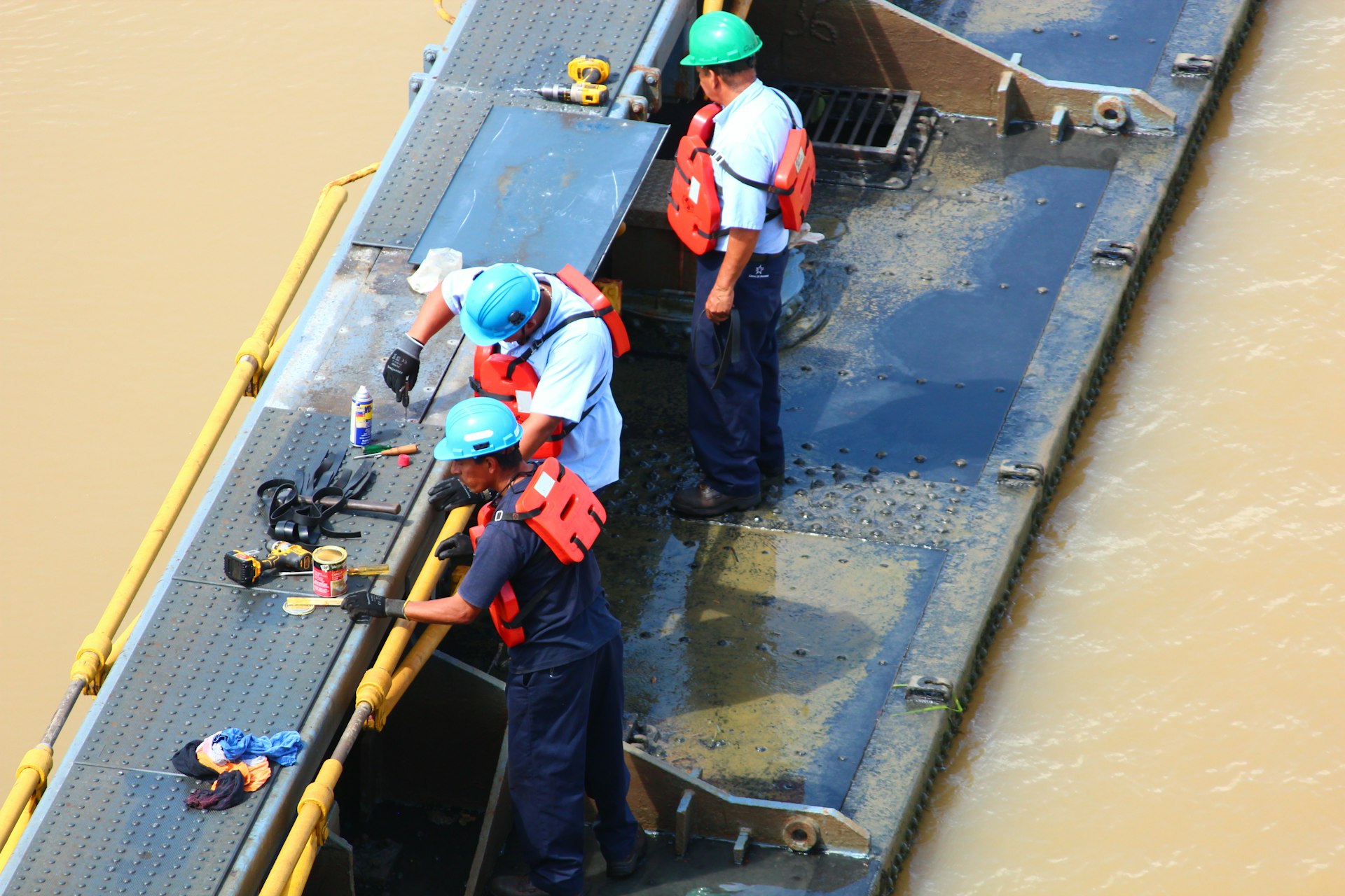a couple of men standing on top of a boat